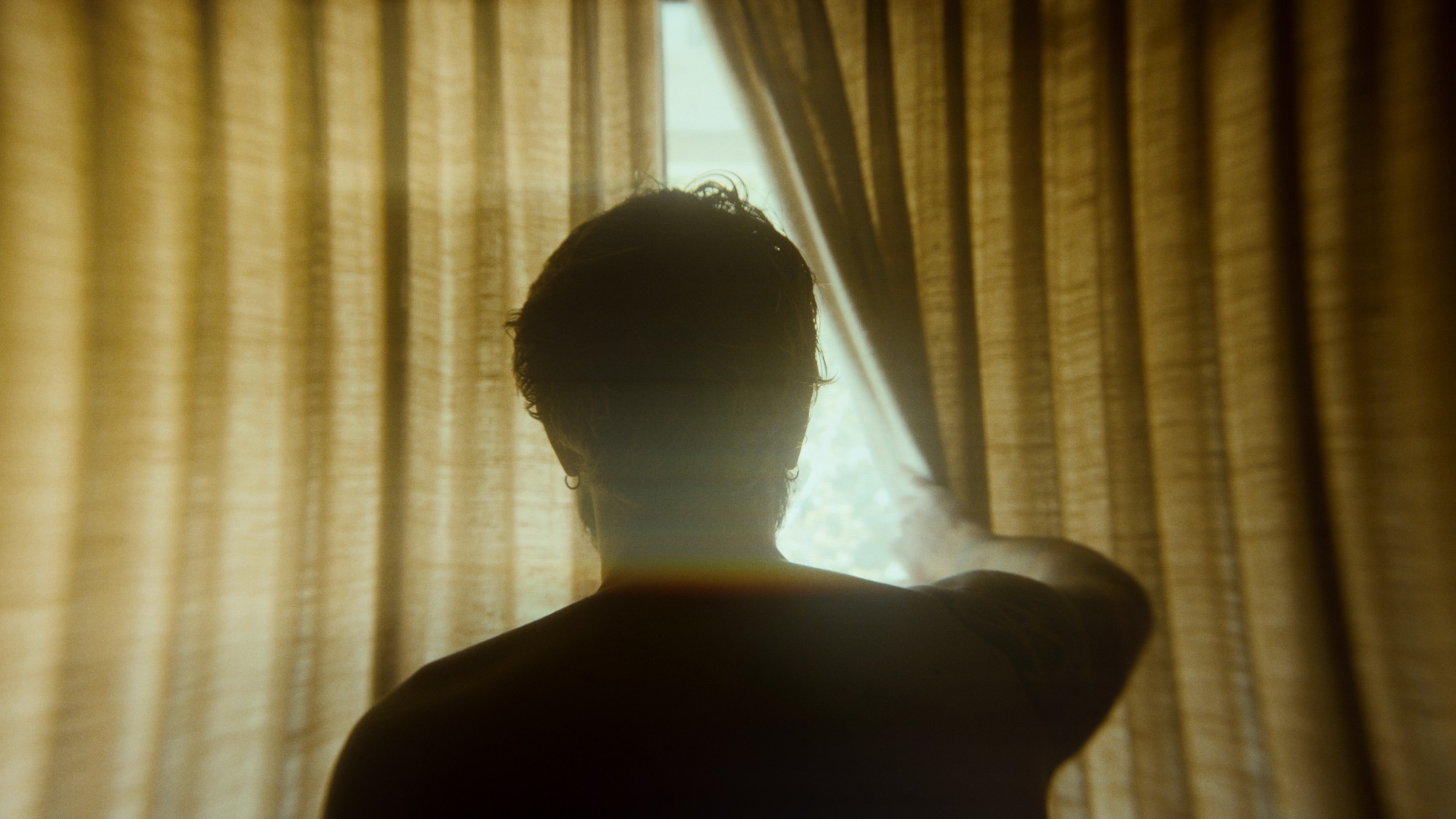 Silhouette drawing back a curtain into daylight, with ShiftBox