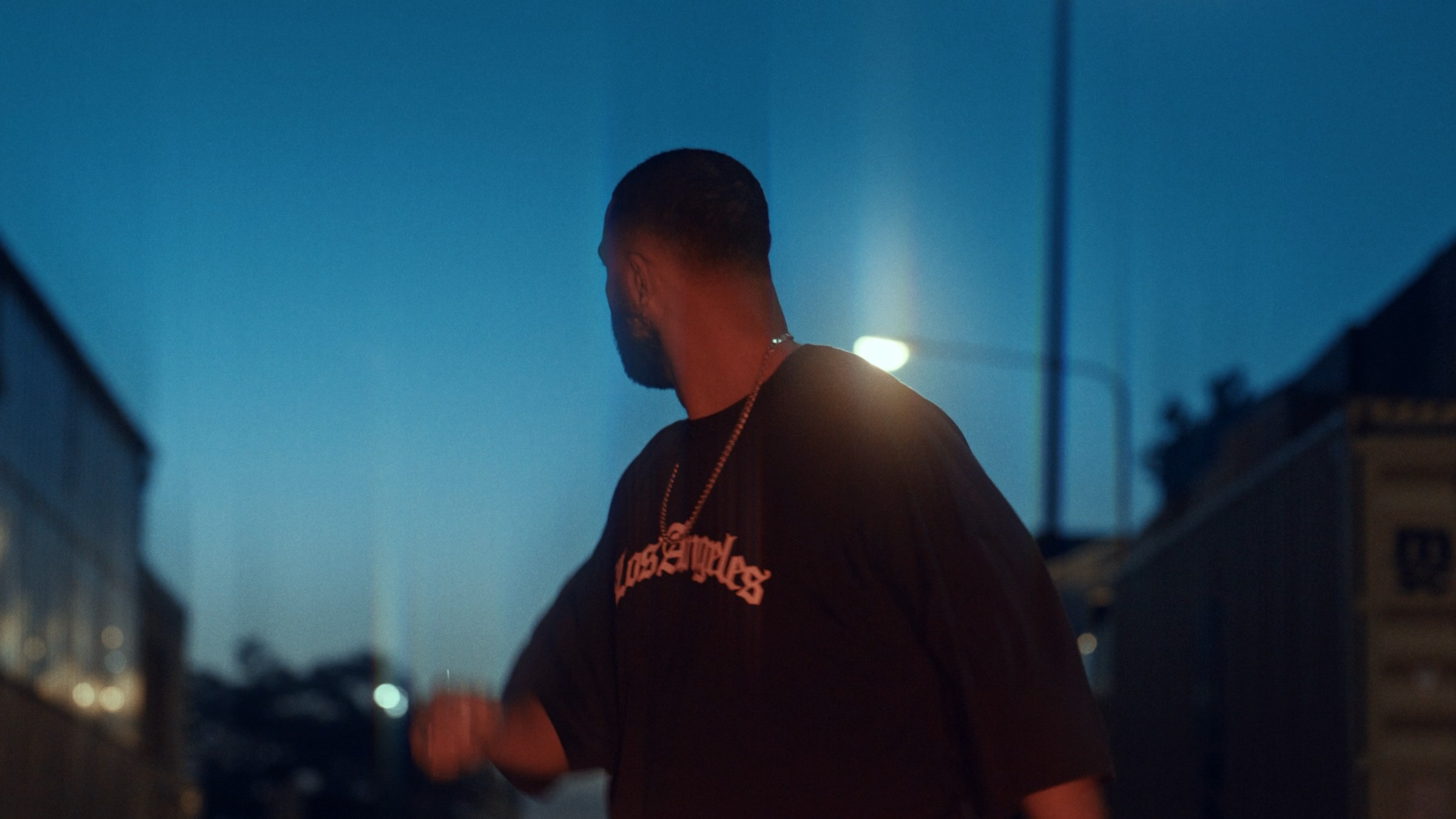 Figure on a street at dusk beneath a streetlight, with ShiftBox